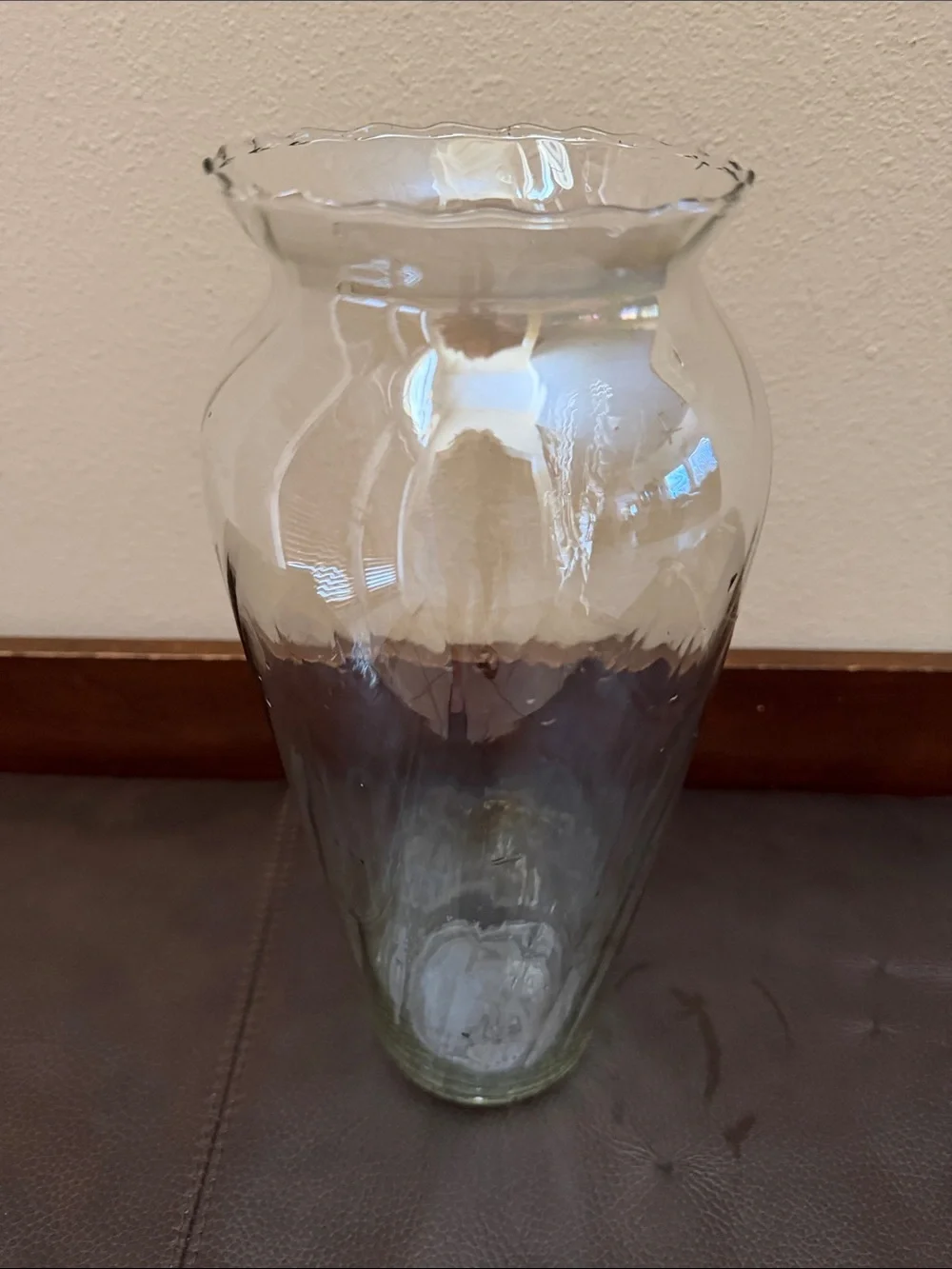 Clear Glass Vase Features Scalloped Rim Opening Tapering Down to a Narrow Base